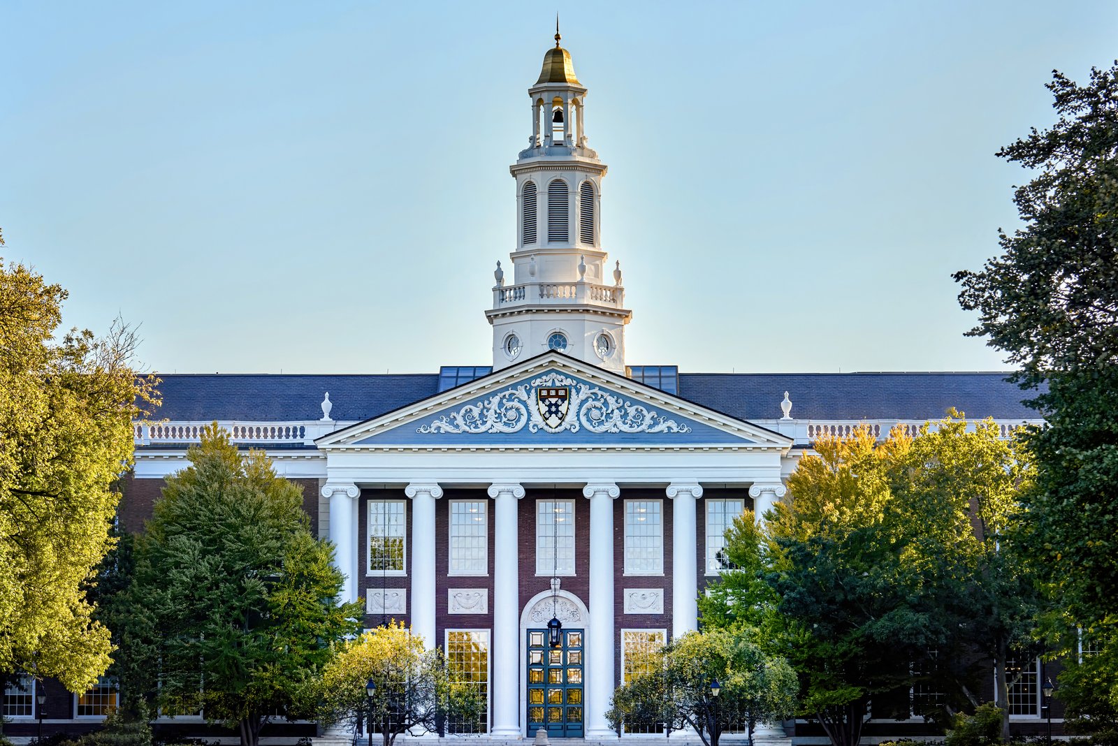 Harvard University with lush green trees on the foreground in Cambridge, USA