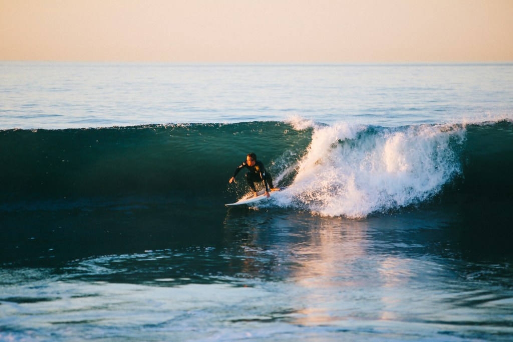 Surfer riding through a wave